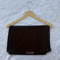 Black fabric on a gold hanger with 'chocolate' text on a textured white background