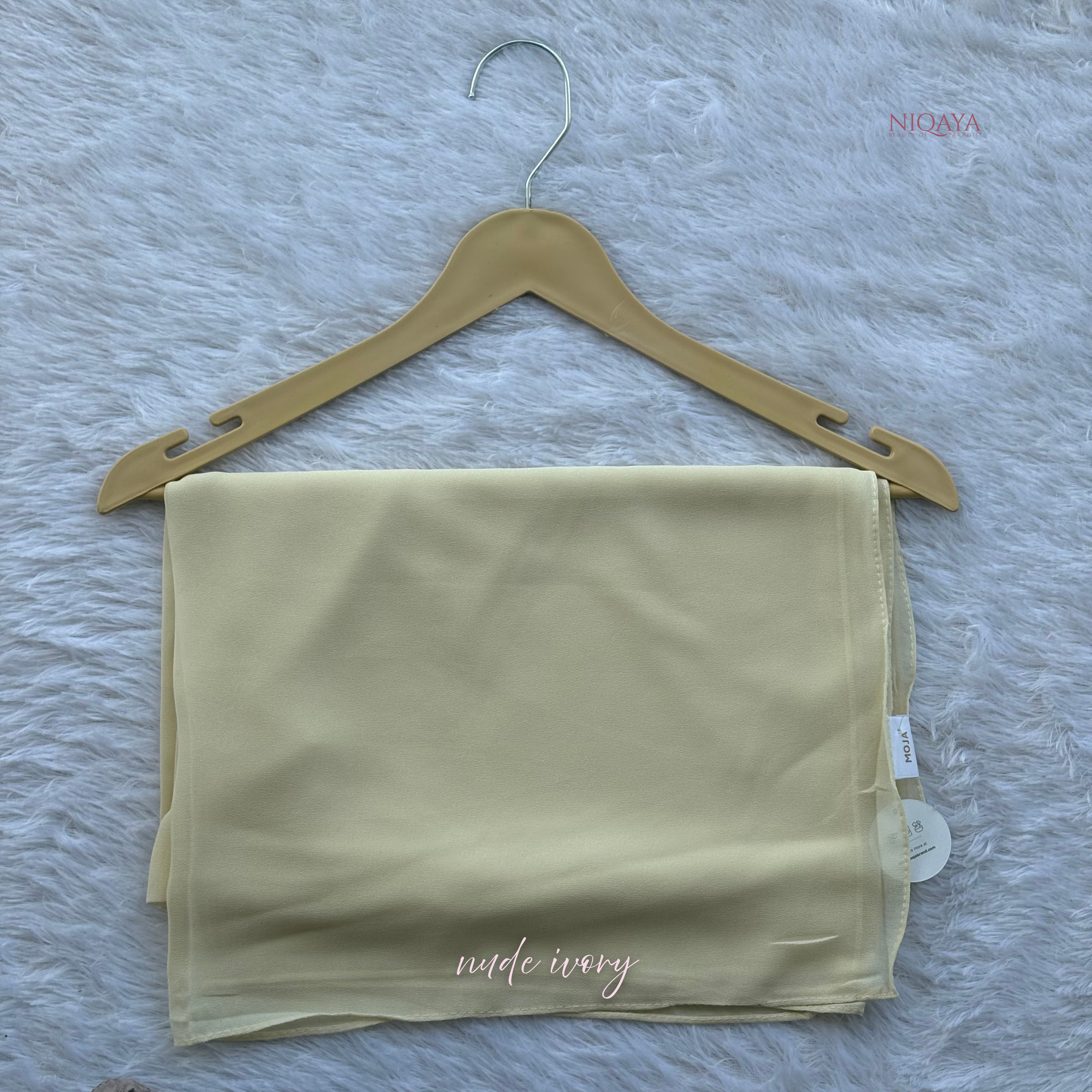 Folded beige fabric on a hanger with 'Nina' branding on a textured gray background