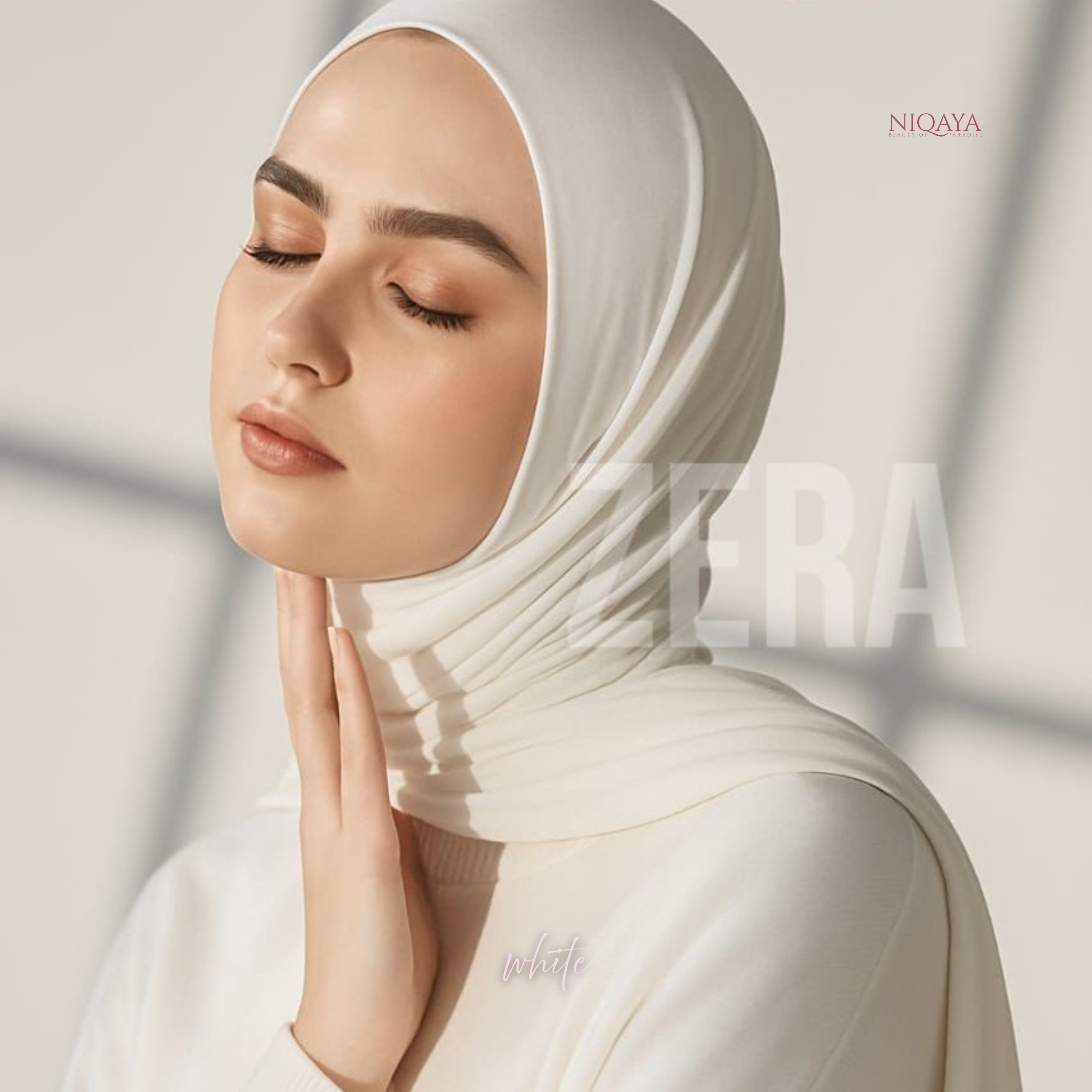 Woman wearing a white hijab with 'NIOQAYA' branding on a light background